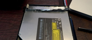 Peel tape off optical drive for SSD iMac Install